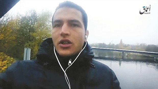 This file image grab taken on December 23 from a propaganda video bearing the logo of Islamic State (IS) group-linked Amaq News Agency (top right), and released on a crypted website shows Anis Amri pledging allegiance to IS. A 40-year-old Tunisian man held on suspicion of being an accomplice of Amri has been freed, prosecutors said yesterday.
