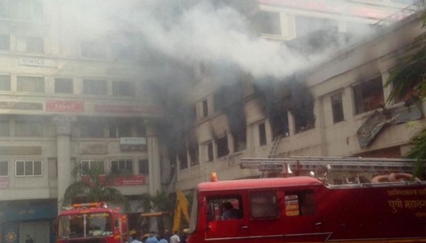 Firefighters and rescue personal at the scene try to evacuate people trapped inside the bakery. Picture courtesy: Mid Day 