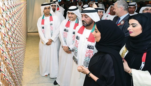 Sheikh Ahmed bin Saeed al-Maktoum and other officials of Emirates view the wall collage of mini-A380 aircraft.