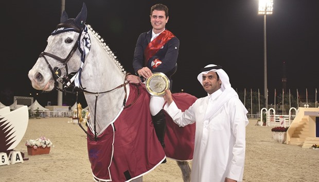 Turkeyu2019s Derin Demirsoy (astride Narazo De Nyze Z) gets his trophy from Qatar Equestrian Federation president Hamad bin Abdulrahman al-Attiyah yesterday.
