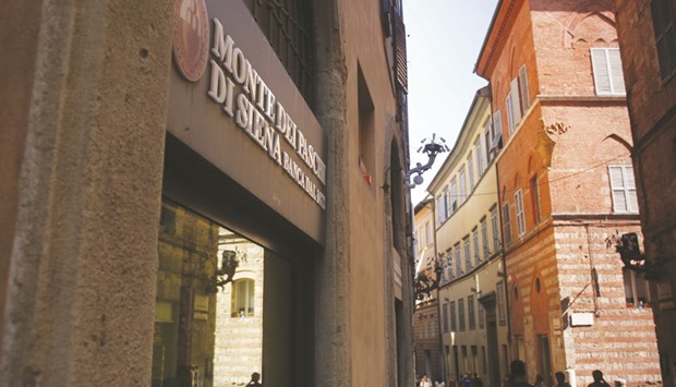 The Monte dei Paschi signage is seen above the entrance to the bank branch in Siena. In the case of Monte dei Paschi, u201cthe immediate cost to the stateu201d under the public option would amount to about u20ac4.6bn.