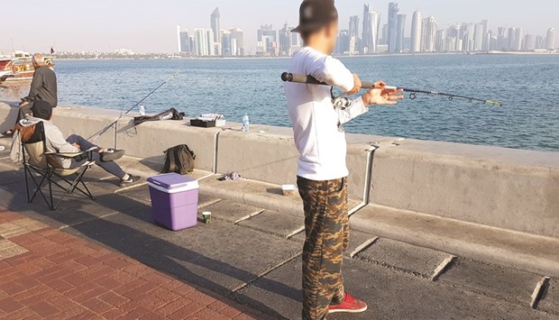 Some residents spend their weekend fishing on the Doha Corniche despite a ban on such activity. PICTURE: Joey Aguilar