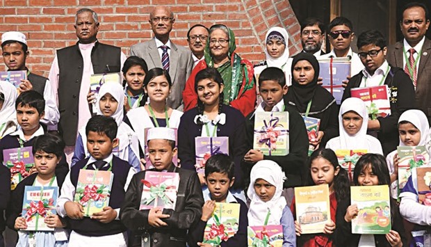 Sheikh Hasina with primary students who were given textbooks in Dhaka yesterday.