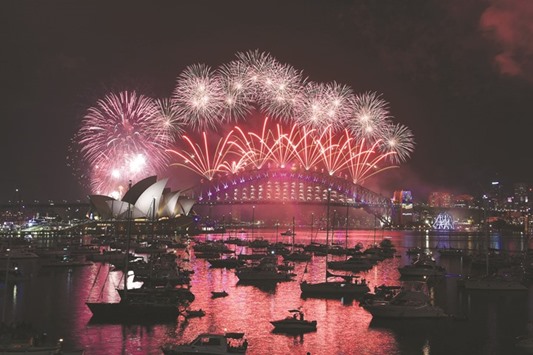 New Year fireworks illuminate the sky over the iconic Opera House and Harbour Bridge in Sydney yesterday.