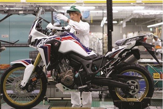 A worker at an assembly line of Honda Motoru2019s Kumamoto factory in Ozu town. For oil importing Japan, Opecu2019s move to cut output is actually a potential positive for the countryu2019s central bank thatu2019s desperate to slay deflation once and for all, sources said.