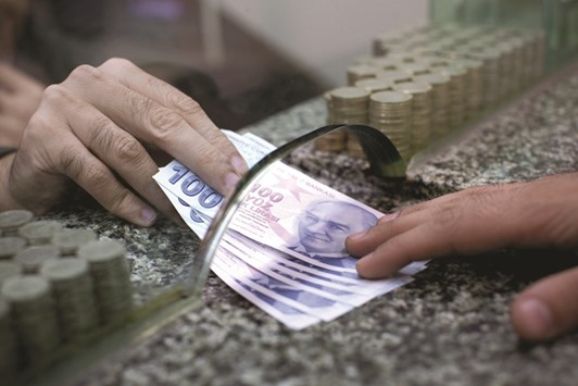 Turkish 100 lira bank notes are exchanged on a currency store counter in Istanbul. Turkish non-financial companies have a net foreign exchange shortfall of $212.8bn, an amount equivalent to more than 25% of gross domestic product, according to central bank data published on Friday.
