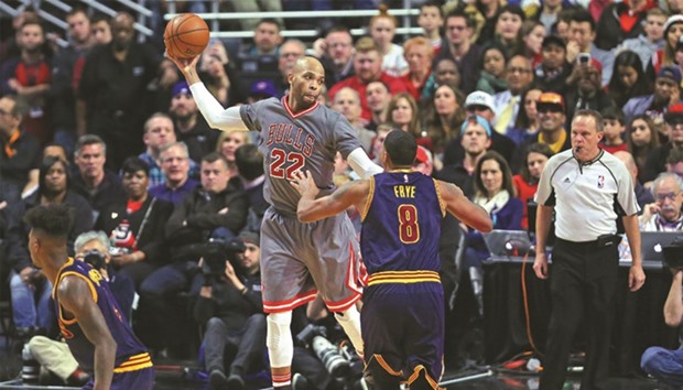 Chicago Bulls forward Taj Gibson (22) catches a pass over Cleveland Cavaliers forward Channing Frye (8) during the second half at the United Center.