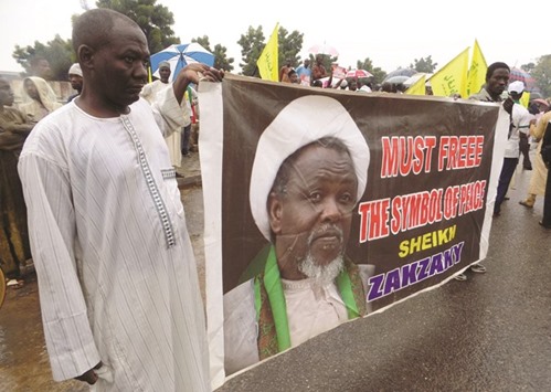 This file photo taken on August 11 shows IMN protesters holding a banner with a photograph of detained leader Zakzaky in the northern city of Kano.