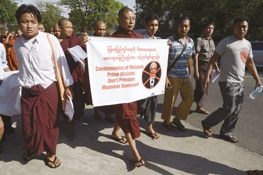 A group of Myanmar Buddhist monks stage a protest outside the Malaysian embassy in Yangon yesterday to denounce Malaysiau2019s Prime Minister Najib Razaku2019s support for the persecuted Rohingya minority.