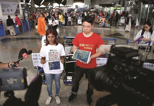 Grace Nathan (left), whose mother Anne Daisy was on board the missing Malaysia Airlines flight MH370, and Chinese national Jiang Hui, who also had a relative on board the flight, address the media prior to departing for Madagascar from Kuala Lumpur International Airport in Sepang yesterday.