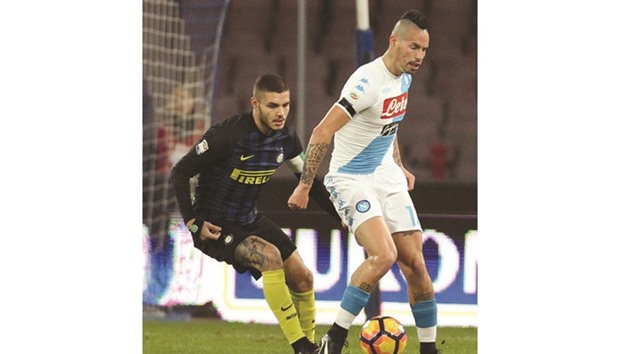 Napoliu2019s Marek Hamsik (right) and Inter Milanu2019s captain Mauro Icardi vie for the ball during the Italian Serie A football match at the San Paolo Stadium on Friday night.  (AFP)