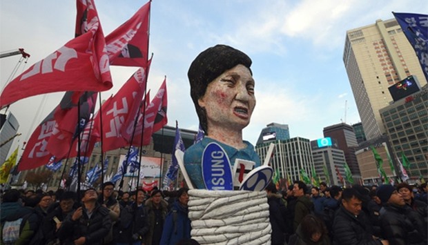 Protesters carry an effigy of South Korea's President Park Geun-Hye