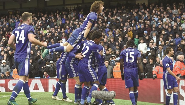 Chelsea players celebrate after midfielder Eden Hazard scored the teamu2019s third goal during the English Premier League match against Manchester City at the Etihad Stadium in Manchester. (AFP)