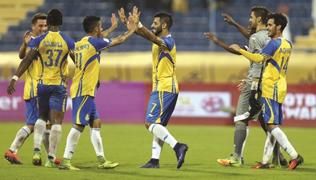 Al Gharafa players celebrate their win over Al Rayyan in the Qatar Stars League yesterday.