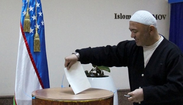 A man casts his ballot during a presidential election in Tashkent, Uzbekistan
