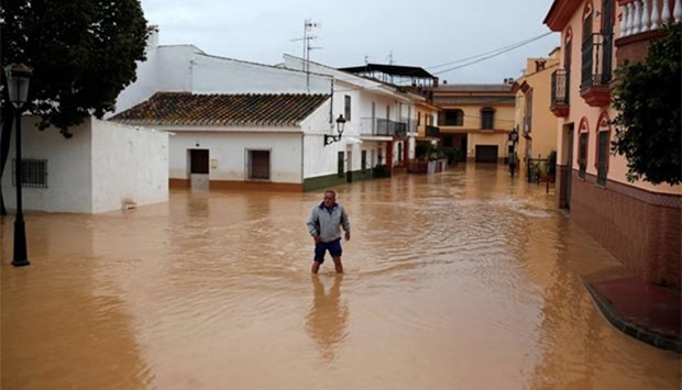 A man walks in floodwaters in Cartama, near Malaga in southern Spain, on Sunday.