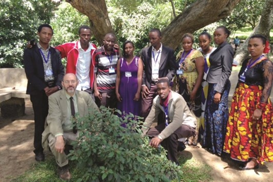 ON THE GROUND: Dr Timothy Coble, left, with volunteers and team members at St Pius in, Arusha, Tanzania.