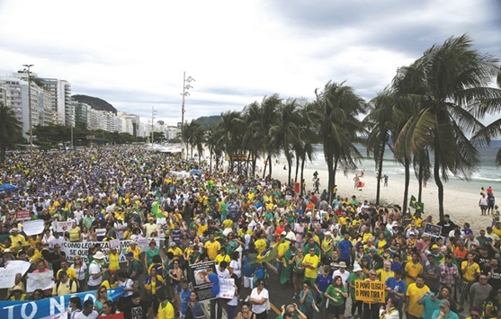 Thousands gather during a protest against corruption at the Copacabana beach in Rio de Janeiro, Brazil, yesterday.