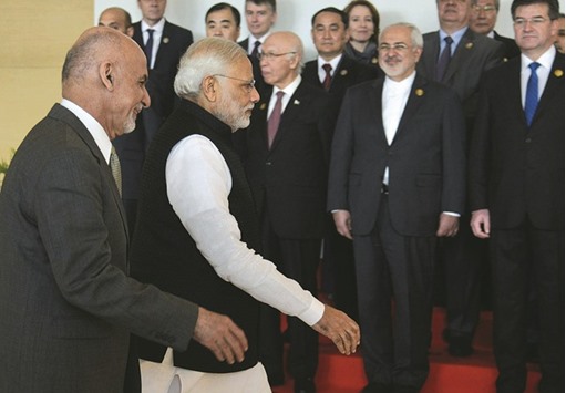 Prime Minister Narendra Modi and Afghan President Ashraf Ghani arrive for the Heart of Asia conference in Amritsar yesterday.