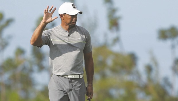 Tiger Woods of the United States waves after putting on the 11th hole during round three of the Hero World Challenge.