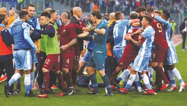 Lazio and AS Roma players get involved in a scuffle during the Italian Serie A match at the Olympic Stadium in Rome, Italy, yesterday. (Reuters)