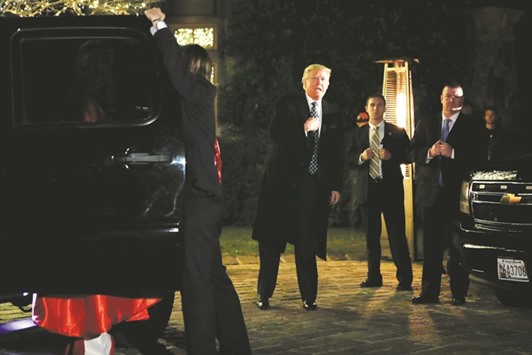 Donald Trump points to himself when asked who he is dressed as, as he arrives at a costume party at the home of hedge fund billionaire and campaign donor Robert Mercer in Head of the Harbor, New York.