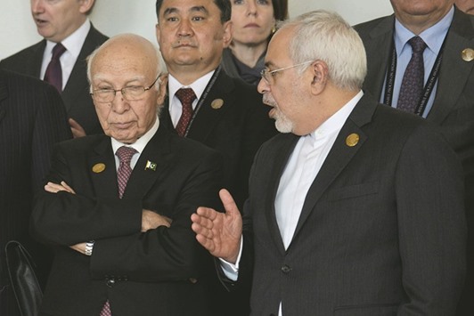 Sartaj Aziz and Iranian Foreign Minister Mohammad Javad Zarif  talk as they wait for the group picture during the 6th Heart of Asia (HoA) Ministerial Conference in Amritsar yesterday.