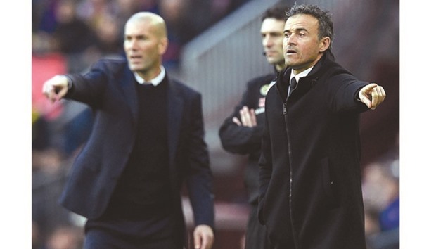 Barcelonau2019s coach Luis Enrique (right) and his Real Madrid counterpart Zinedine Zidane gesture from the sideline during the El Clasico at the Camp Nou stadium on Saturday. (AFP)