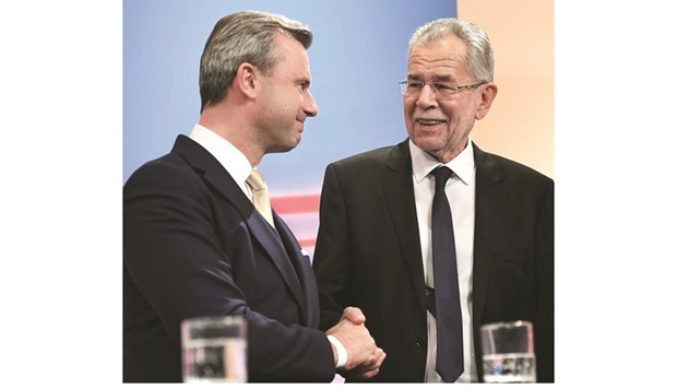 Hofer (left) congratulating Van der Bellen at a post-election TV talk in Vienna yesterday.