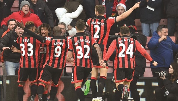 Bournemouthu2019s Dutch defender Nathan Ake (second from left) celebrates with teammates after scoring their fourth goal during the English Premier League match against Liverpool at the Vitality Stadium in Bournemouth, southern England, yesterday. (AFP)
