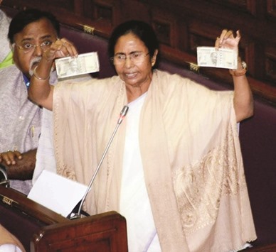 West Bengal Chief Minister Mamata Banerjee shows the new Rs500 notes during her speech in the state assembly yesterday.