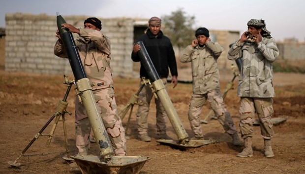 Iraqi soldiers fire mortar shells towards Islamic State positions, in Shayyalah al-Imam near Mosul