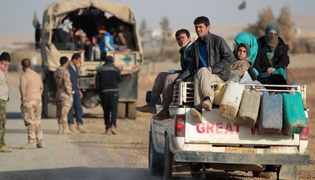 Iraqi families, displaced from the outskirts of the city of Tal Afar, arrive on trucks on December 3, 2016 in the village of Tall al-Zarka after the fled the ongoing fighting between Iraqi forces and the Islamic State (IS) group.