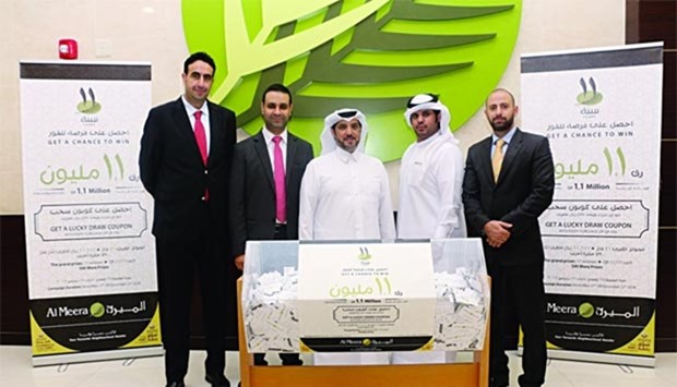 Al Meera officials are pictured during the company's 11th anniversary grand raffle draw.