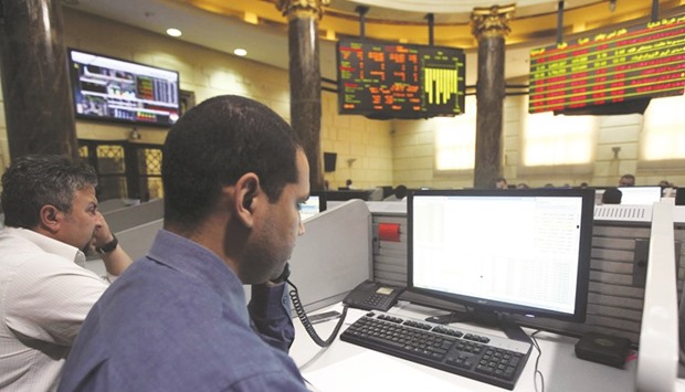 Traders work at the Egyptian Exchange in Cairo. Mena bourses had a positive month in November, with Egyptu2019s HRMS index rising 36.6%, followed by Saudiu2019s TASI index (16.4%), according to Markaz report.