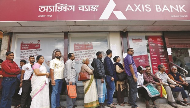 People queue outside a bank to withdraw cash and deposit their old high denomination banknotes in Kolkata. About Rs12.6tn ($185bn) had been deposited into Indian bank accounts as of December 3, sources said.
