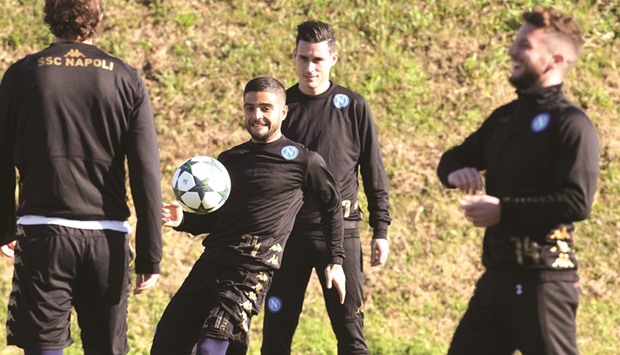 Napoliu2019s Lorenzo Insigne (left) controls the ball near teammate Jose Maria Callejon during a training session on the eve of the UEFA Champions League match against Benfica at the SSC Napoli training ground yesterday. (AFP)