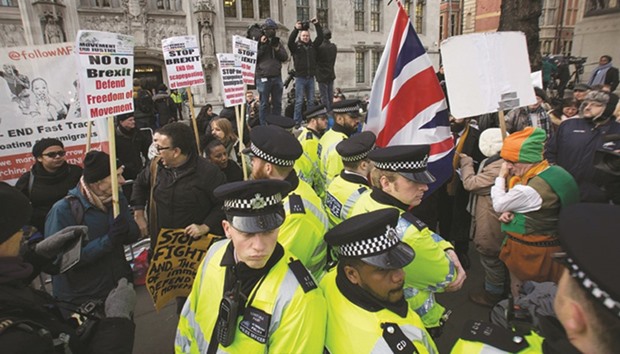 Police officers stand between pro and anti-Brexit demonstrators outside the Supreme Court building in London yesterday.