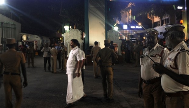 Indian policemen stand in front of a hospital where Jayalalitha is treated