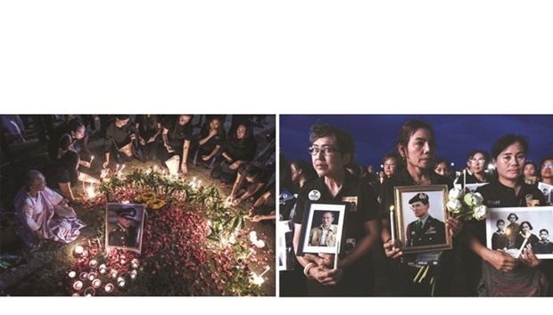People place candles around an image of the late Thai King Bhumibol Adulyadej to commemorate his birthday in Sanam Luang park in front of the Grand Palace in Bangkok yesterday. Right: People hold images of the late Thai king to commemorate his birthday in Sanam Luang park.