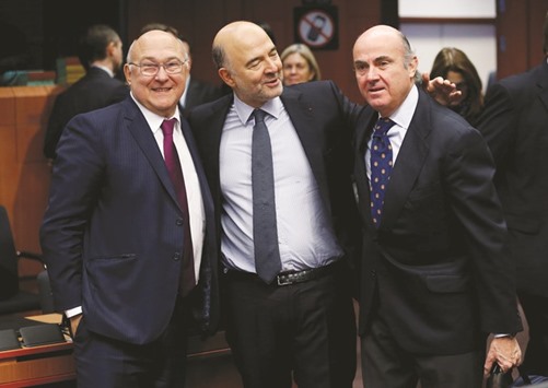 From left: French Finance Minister Michel Sapin, European Economic and Financial Affairs Commissioner Pierre Moscovici, and Spainu2019s Economy Minister Luis de Guindos attend a eurozone finance ministers meeting in Brussels on Monday.
