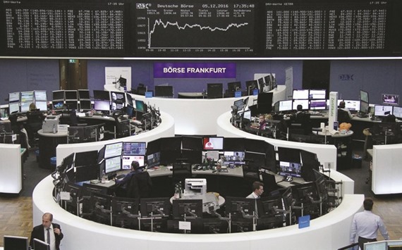 Traders work at the Frankfurt Stock Exchange. The DAX 30 closed up 0.85% to 10,775.32 points yesterday.