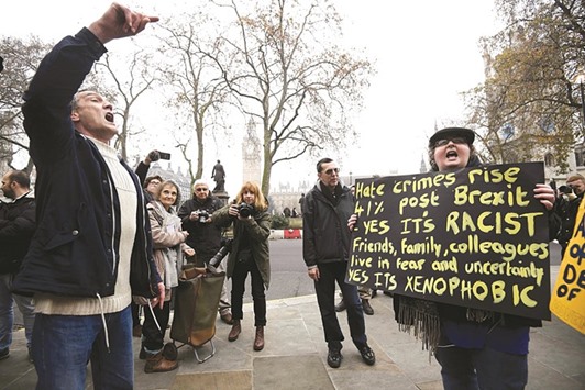 Protesters hold placards and shout outside the Supreme Court on the second day of the challenge against a court ruling that Theresa Mayu2019s government requires parliamentary approval to start the process of leaving the European Union, in Parliament Square, central London, yesterday.