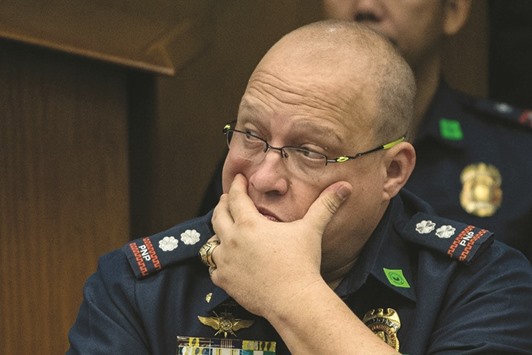 Police Superintendent Marvin Marcos, head of the local Criminal Investigation and Detection Group, who led the deadly raid gestures during a senate hearing in Manila over the death of a town mayor.