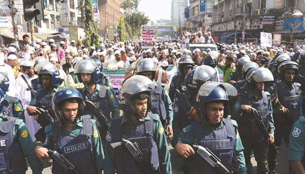 Bangladeshi police stand guard as activists from Islamic organisations march towards the Myanmar embassy in Dhaka yesterday, to protest against the persecution of Rohingya Muslims in Myanmar.