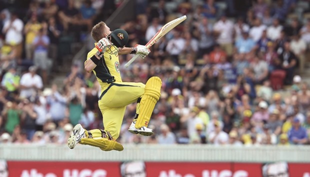Australiau2019s batsman David Warner celebrates his century during the second ODI against New Zealand in Canberra yesterday. (AFP)