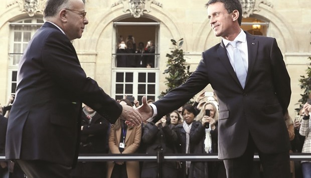 Valls (right) with Cazeneuve at the Hotel Matignon in Paris, prior to the start of the handover ceremony after Valls resigned as premier to seek the Socialist nomination in next yearu2019s presidential election.