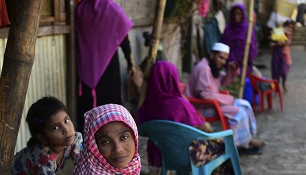 Myanmar Rohingya refugees look on in a refugee camp in Teknaf, in Bangladesh
