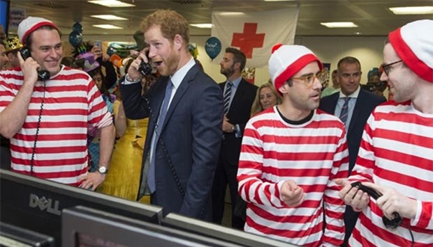 Prince Harry mans the phones at the 24th annual ICAP Charity Day at the offices of ICAP brokers in central London on Wednesday.