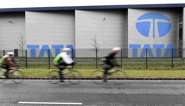 Cyclists ride past the Tata steelworks in the town of Port Talbot, Wales.